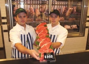 Indooroopilly butchery staff Nathan Laughton and Matt O' Sullivan with Wagyu strips at $50/kg, and dry aging cabinet at rear