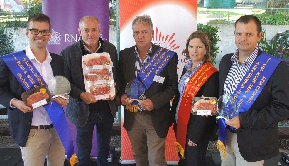 JBS's Brad de Luca, Dennis Connolly nd fewllow staff are congratulated by judge John Kilroy after the company's wins in Friday's branded beef competition