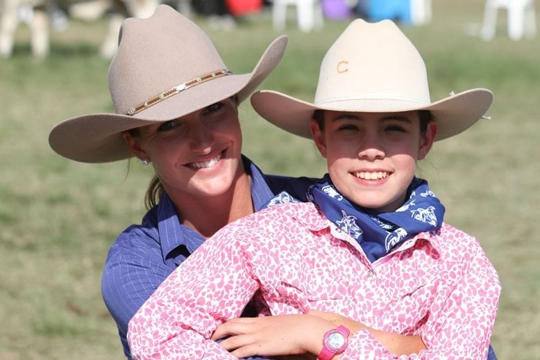 Samantha Cooksley, Spenbar, Condamine and Georgie Coombe, Bindaree, Moura enjoying the action in the Brahman ring.