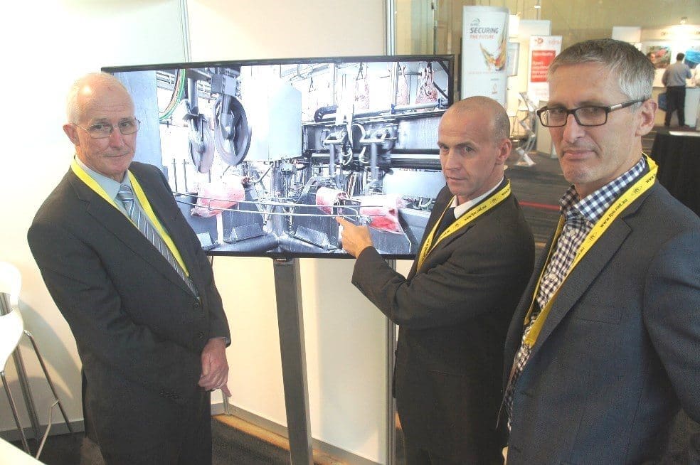 Stanbroke Beef's Ian Ball and Alastair Ronald look over a video of Scott Technology's automation systems with the company's Sean Starling.