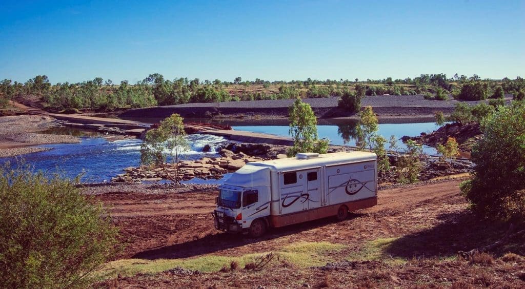 Every year since 1991, Lyle and Helen Kent have taken their Kent's Saddlery retail business on the road, visiting up to 150 remote stations across Northern Australia. They are pictured here at a river crossing on the Duncan Highway in the NT.