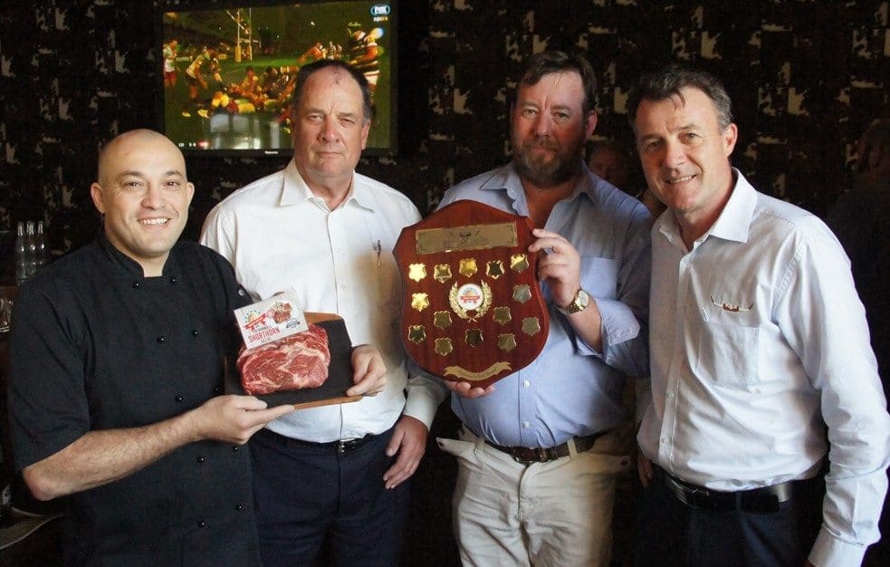 Graham Winnell from the Shorthorn Society accepts the perpetual trophy for the Norman Hotel's annual "You Be the Judge" breed comparison